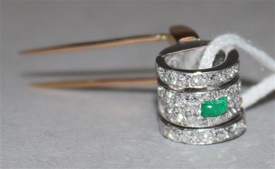 A diamond and emerald set pin